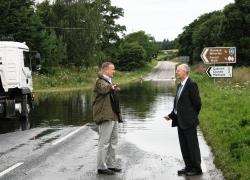 Cllr Drew Hendry and area roads manager Richard Evans inspect the site of the A862 flooding