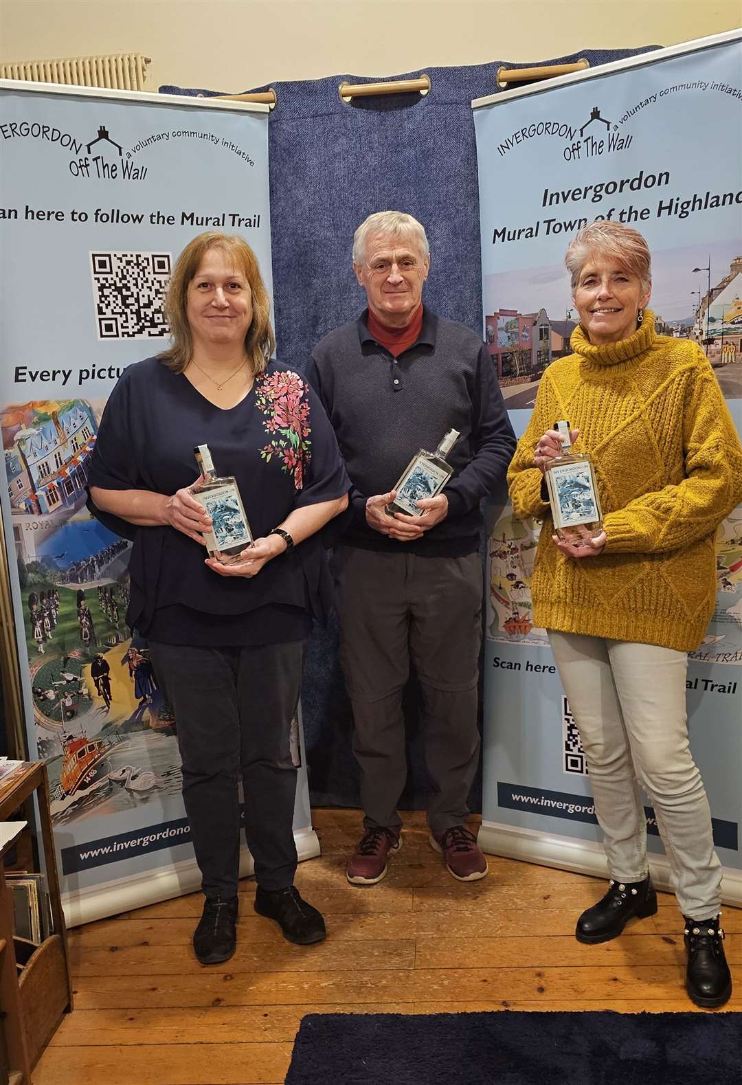 Off the Walls's Jacky Roberts (left), chairman Sonny Rhind and Julie Coghill with the gin.